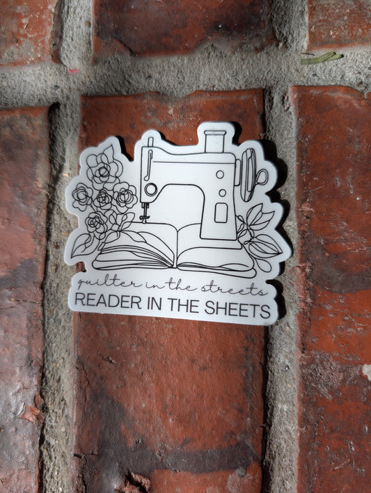 Sticker with a sewing machine design on a brick wall